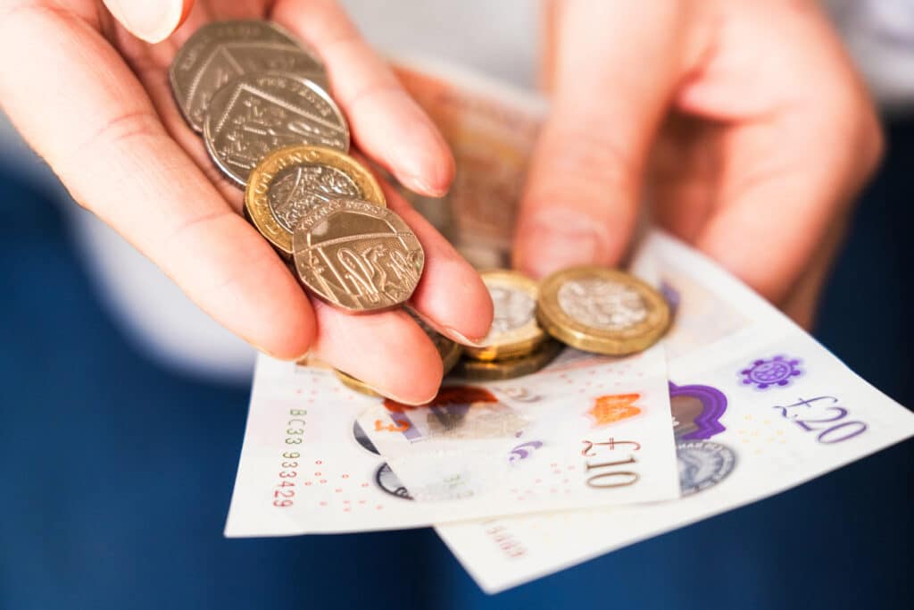 UK coins in hand 1024x683 - Why Collect Coins? A Journey Through History and Discovery
